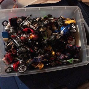 A bunch of Hot Wheels, toy cars and motorcycles